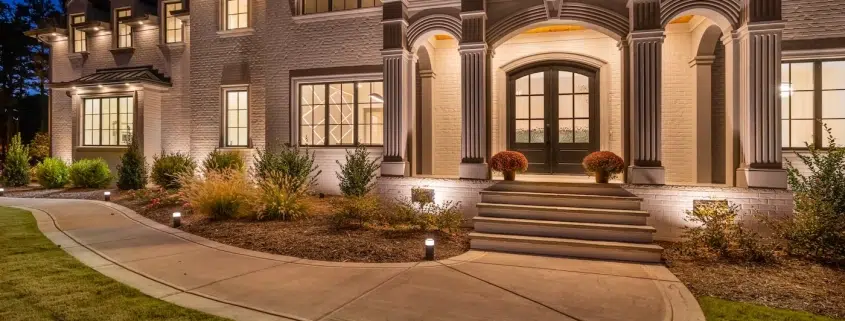 Elegant modern house exterior with nighttime lighting.