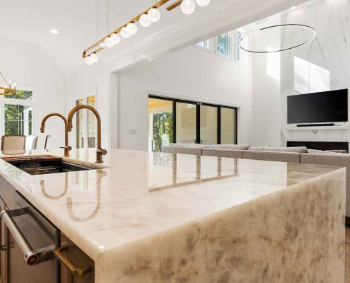 Modern kitchen countertop with elegant lighting and marble island.