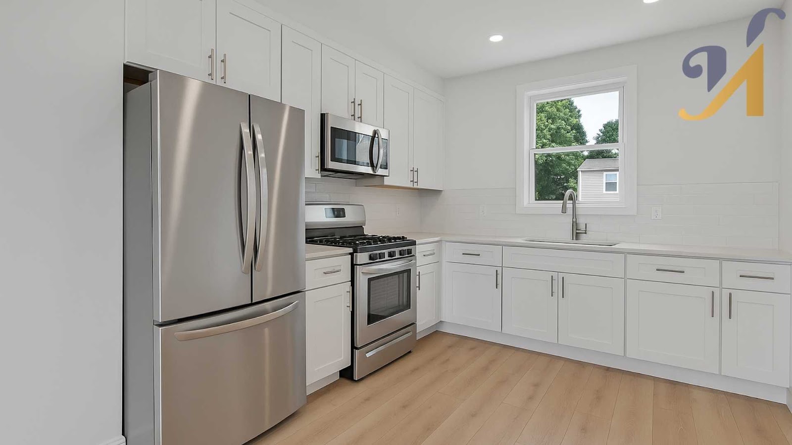 Modern L-shaped kitchen with stainless steel appliances.