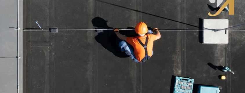 Rooftop worker with tools and safety gear.