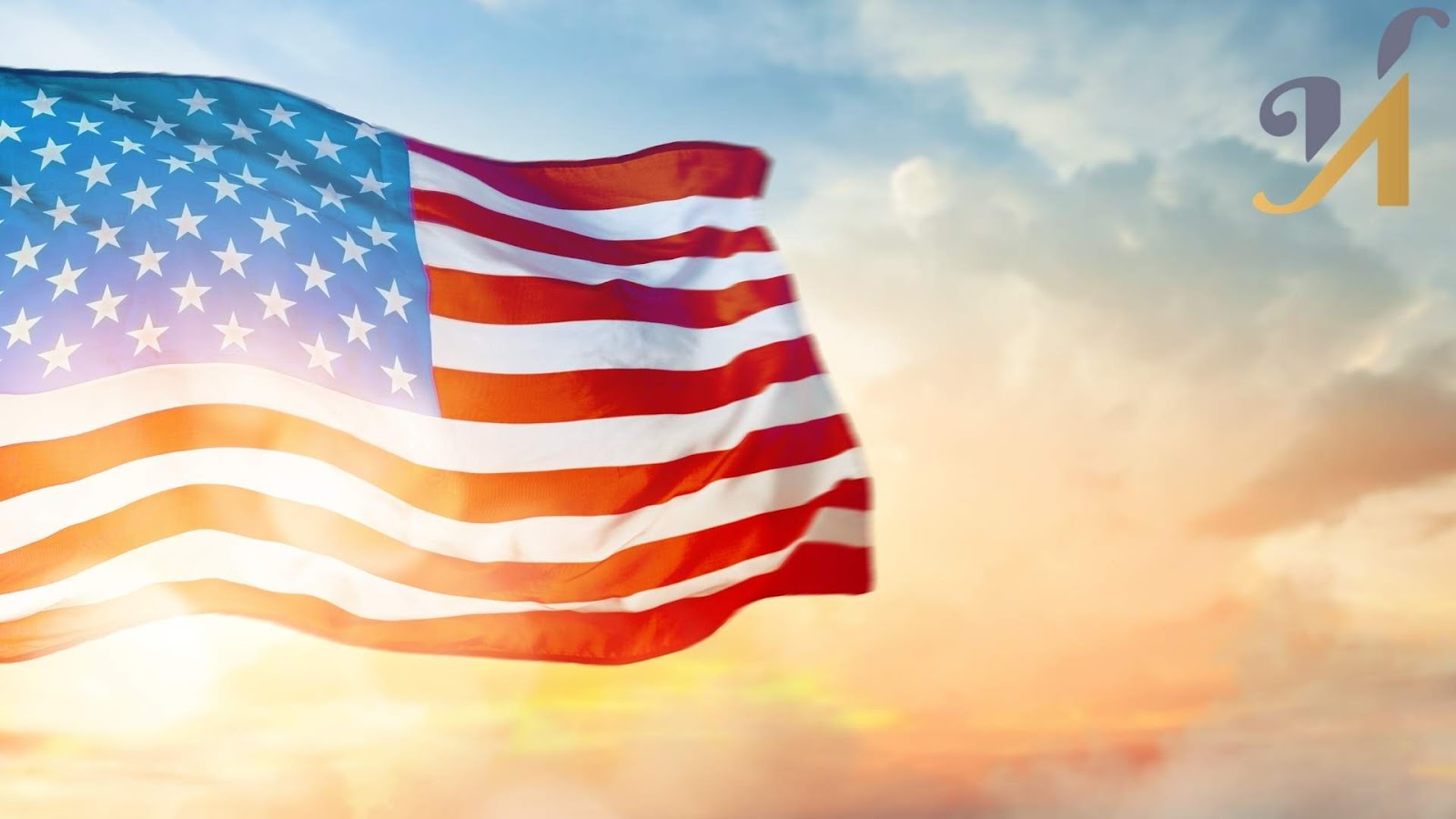 American flag waving in the sunset sky.