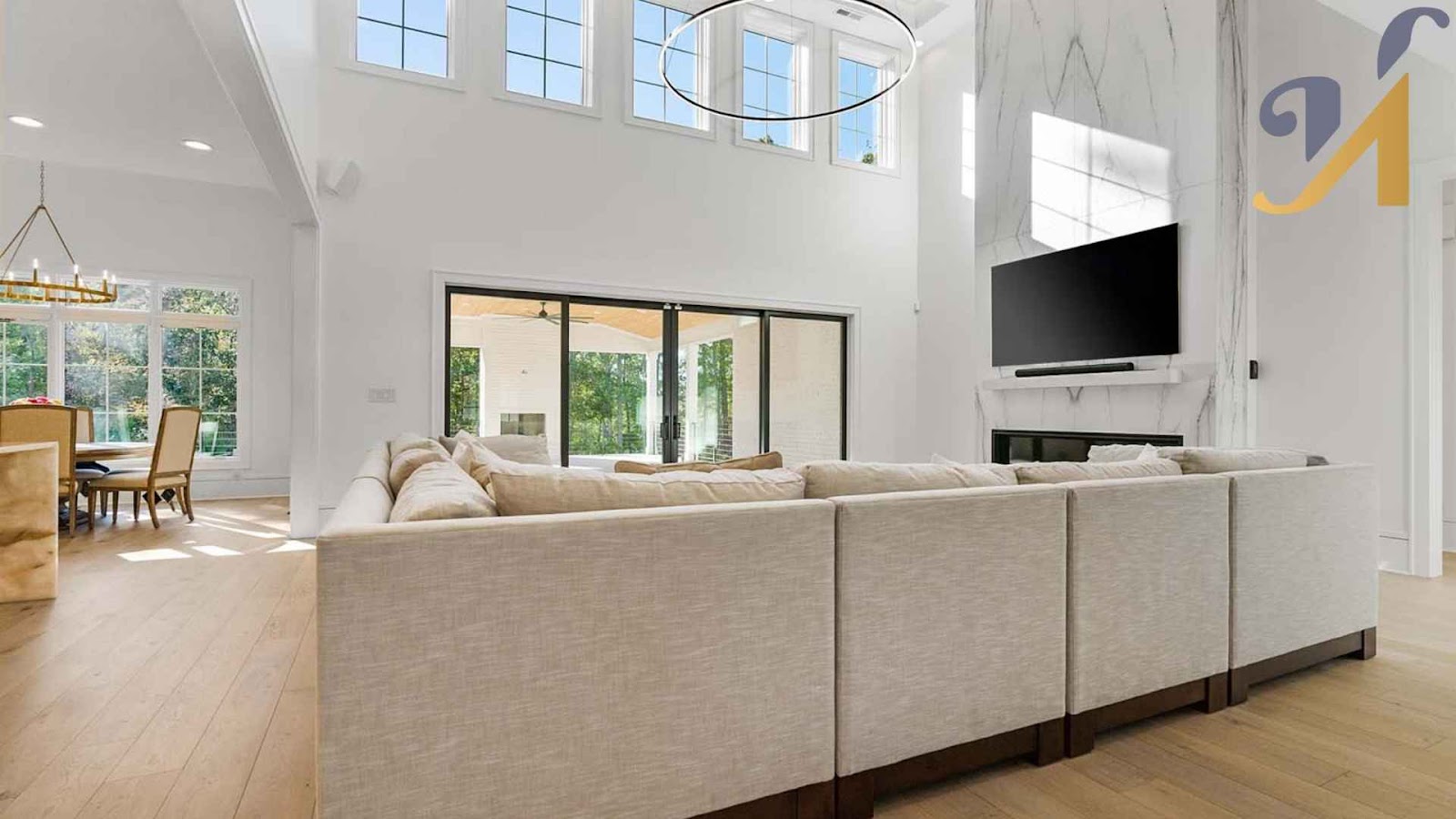 Spacious living room with large windows and sectional sofa.