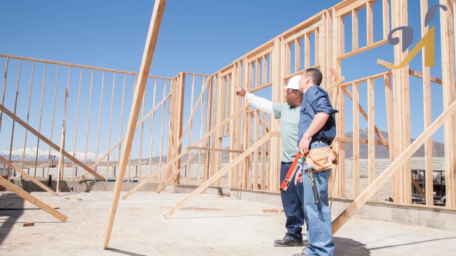 Construction workers examining wooden framework on site